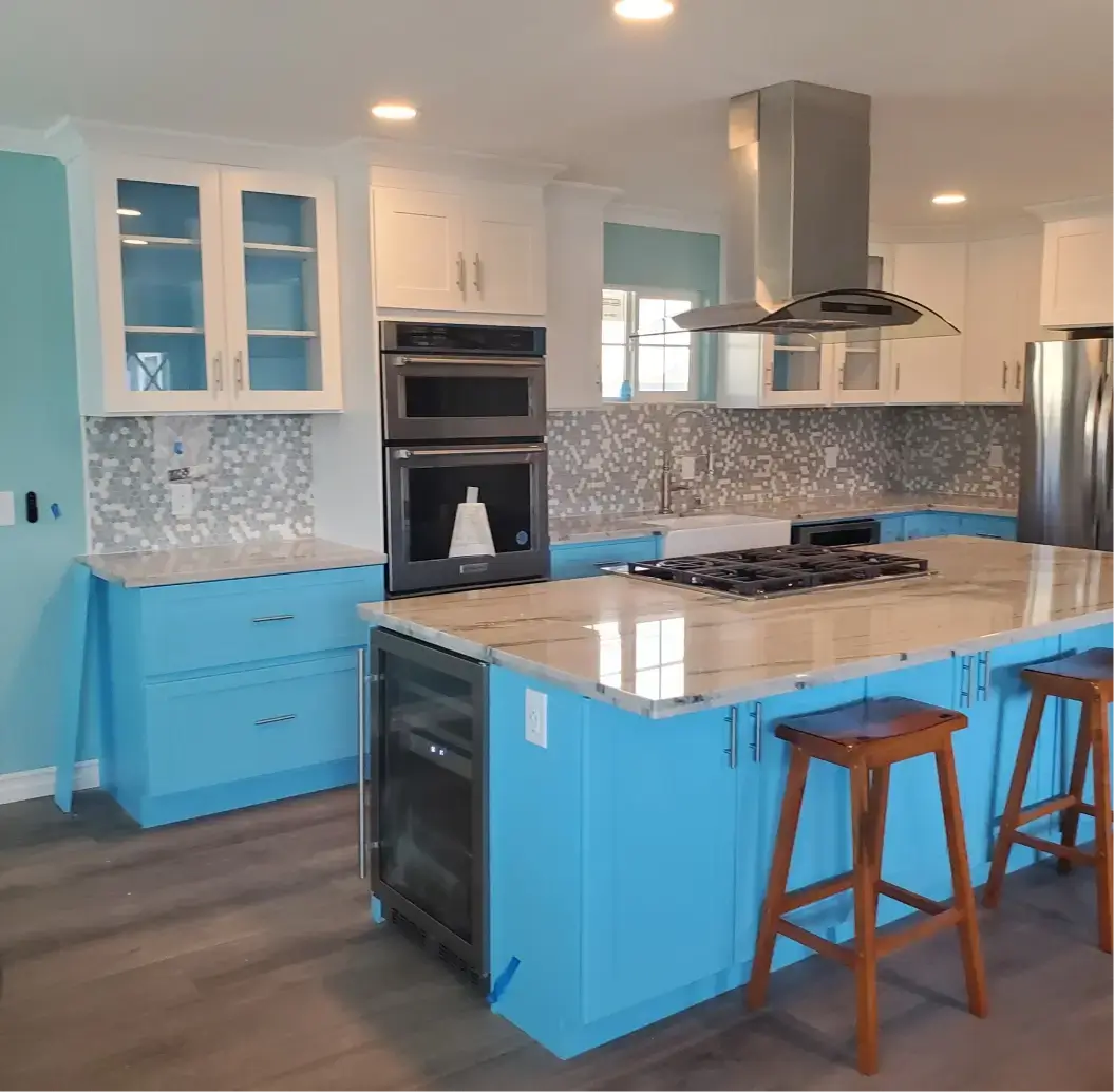 Modern kitchen with blue cabinets and island.