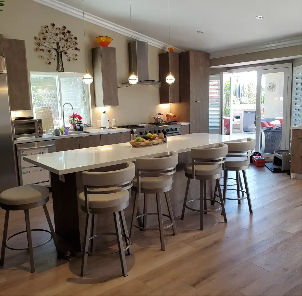 Modern kitchen with island and bar stools.